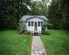 Light-colored siding exterior with a dark-shingle roof Light-colored siding exterior with a dark-shingle roof