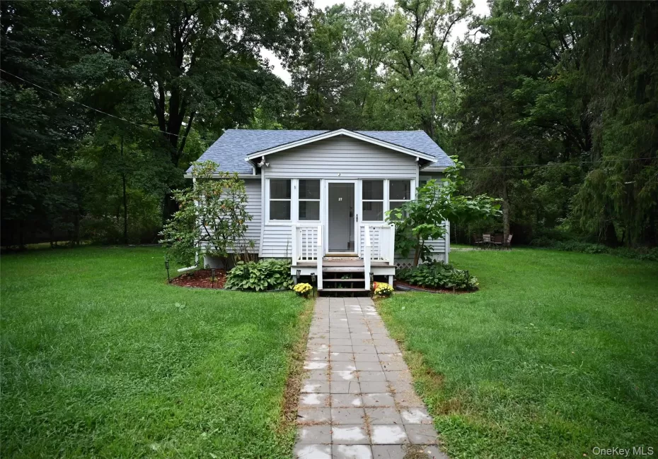 Light-colored siding exterior with a dark-shingle roof Light-colored siding exterior with a dark-shingle roof