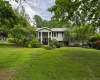 Expansive front lawn with mature trees and established landscaping Expansive front lawn with mature trees and established landscaping