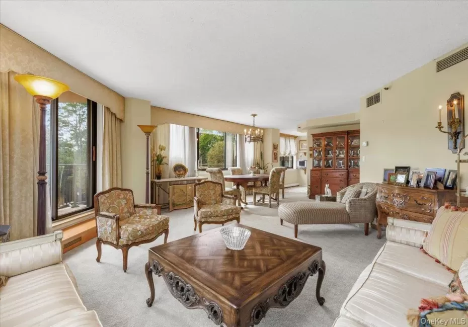 Sun-filled iving and dining areas with 2 sets of glass doors to wrap around balcony. Sun-filled iving and dining areas with 2 sets of glass doors to wrap around balcony.