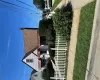 Gable roofline with asphalt shingles, white horizontal siding, and a red awning Gable roofline with asphalt shingles, white horizontal siding, and a red awning