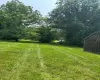 View of grassy yard featuring a storage unit View of grassy yard featuring a storage unit