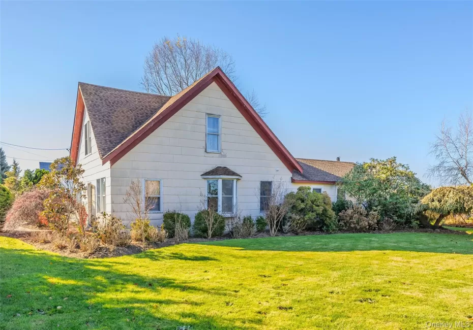 View of property exterior with a yard and a shingled roof View of property exterior with a yard and a shingled roof