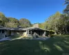 View of property exterior featuring a lawn and a chimney View of property exterior featuring a lawn and a chimney