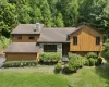 Wood-finish siding with stone accents and a stone chimney Wood-finish siding with stone accents and a stone chimney