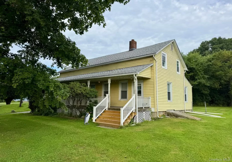 Two-story residence with yellow siding and white trim Two-story residence with yellow siding and white trim