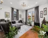 Hardwood flooring, recessed lighting, and large windows with dark trim Hardwood flooring, recessed lighting, and large windows with dark trim