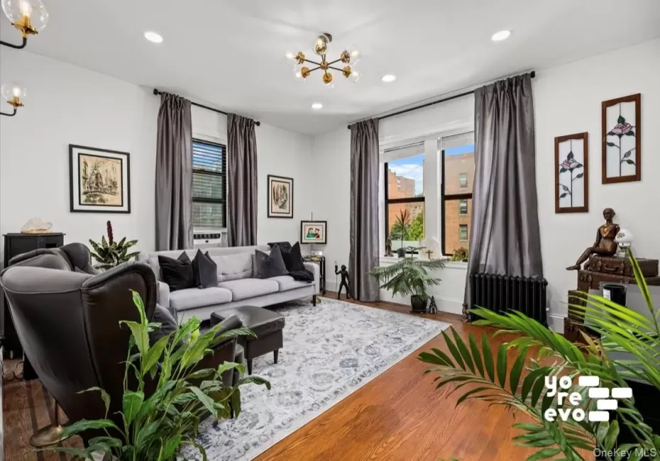Hardwood flooring, recessed lighting, and large windows with dark trim Hardwood flooring, recessed lighting, and large windows with dark trim