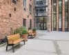 Brick exterior with a prominent glass entry, multiple large windows, and a concrete paver walkway Brick exterior with a prominent glass entry, multiple large windows, and a concrete paver walkway