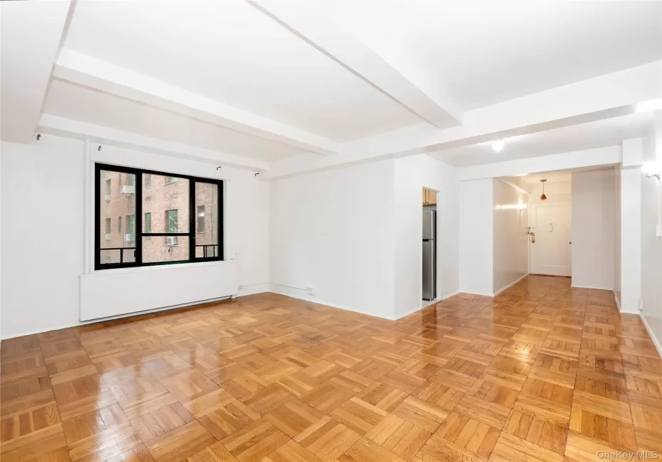 Recessed ceiling beams, large multi-pane window, wood-finish parquet flooring Recessed ceiling beams, large multi-pane window, wood-finish parquet flooring