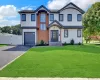 Contemporary two-story exterior with white siding and dark trim Contemporary two-story exterior with white siding and dark trim