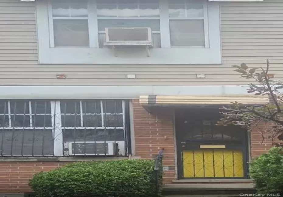 Brick and siding exterior with a security screen door and window security bars Brick and siding exterior with a security screen door and window security bars