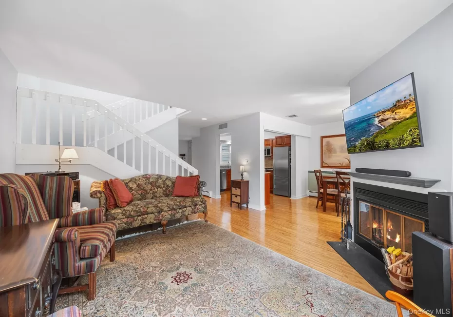 Living area with fireplace and staircase to 2nd level. Living area with fireplace and staircase to 2nd level.