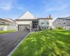 Contemporary exterior with a stone facade, a two-car garage, and a paved driveway Contemporary exterior with a stone facade, a two-car garage, and a paved driveway