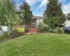 Tri-level home featuring a front lawn, solar panels, brick siding, a garage, and a shingled roof Tri-level home featuring a front lawn, solar panels, brick siding, a garage, and a shingled roof