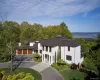 Magnificently set on 1.5 acres surrounded by lush lawns and beautiful perennial landscaping. Magnificently set on 1.5 acres surrounded by lush lawns and beautiful perennial landscaping.