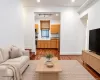 Hardwood flooring extends throughout the living area and into the kitchen Hardwood flooring extends throughout the living area and into the kitchen