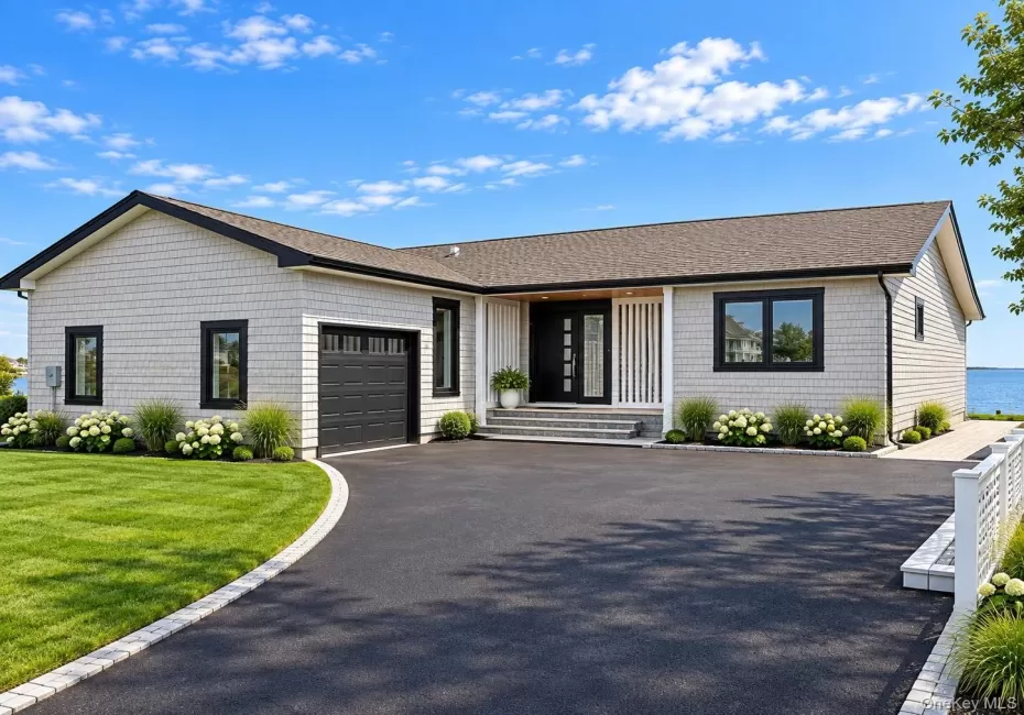 Shingle siding exterior with black-framed windows and a dark roof Shingle siding exterior with black-framed windows and a dark roof
