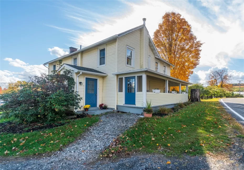 View of front of property with a chimney, a front yard, and a porch View of front of property with a chimney, a front yard, and a porch