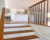 Hardwood staircase with painted risers and a wood newel post Hardwood staircase with painted risers and a wood newel post