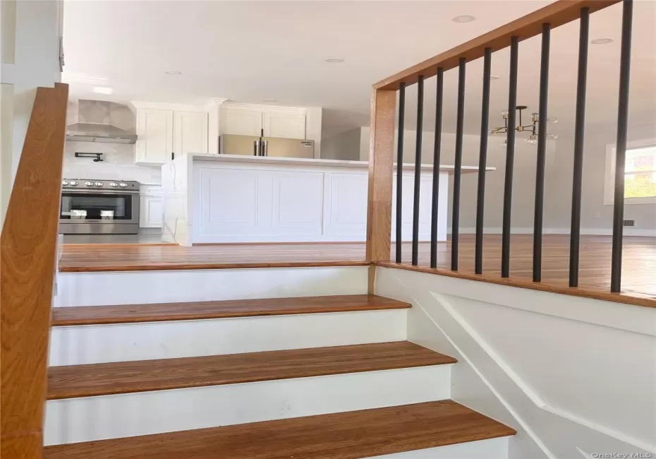 Hardwood staircase with painted risers and a wood newel post Hardwood staircase with painted risers and a wood newel post