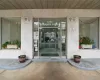 The property features a building entrance with glass doors and large display windows on either side, set within a light-colored facade The property features a building entrance with glass doors and large display windows on either side, set within a light-colored facade