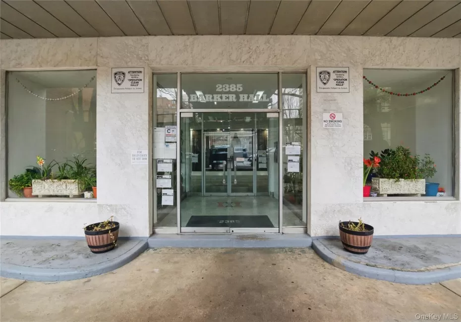 The property features a building entrance with glass doors and large display windows on either side, set within a light-colored facade The property features a building entrance with glass doors and large display windows on either side, set within a light-colored facade