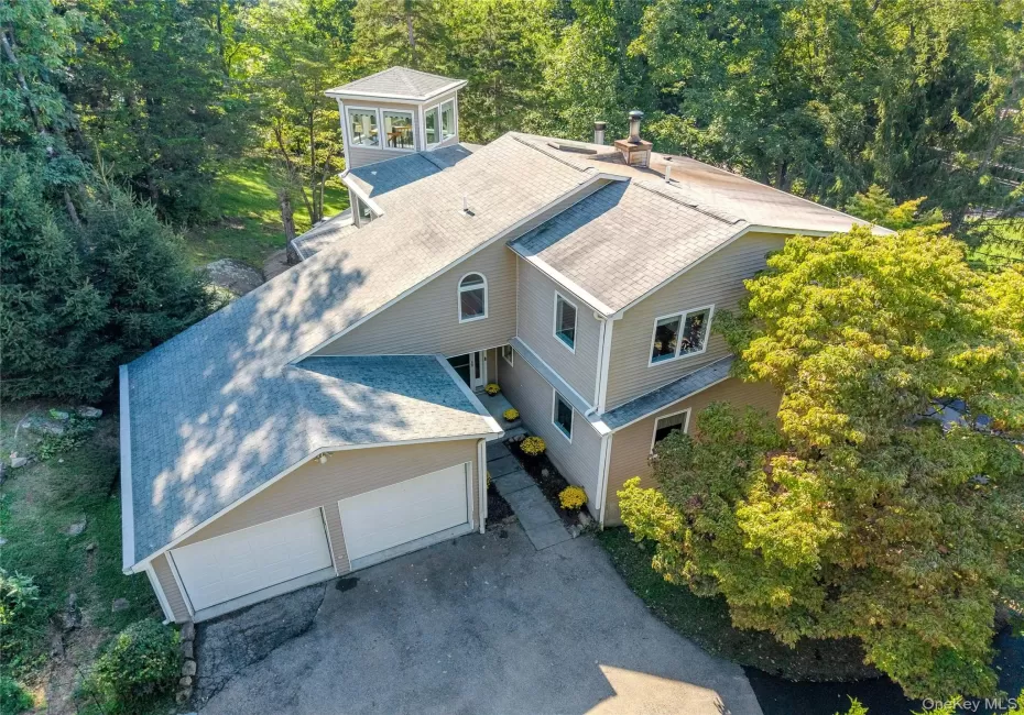 This home’s distinctive design comes to life from this angle, with the unique “Crow’s Nest” rising above and adding character, charm, and a memorable architectural touch. This home’s distinctive design comes to life from this angle, with the unique “Crow’s Nest” rising above and adding character, charm, and a memorable architectural touch.