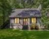 Siding exterior with a gabled roof, prominent chimney, and a front entry with double doors Siding exterior with a gabled roof, prominent chimney, and a front entry with double doors