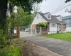View of front of home with brick siding, a shingled roof, fence private yard, aphalt driveway, and a gate View of front of home with brick siding, a shingled roof, fence private yard, aphalt driveway, and a gate