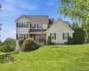 Two-story residence featuring light-colored siding and stone accents Two-story residence featuring light-colored siding and stone accents