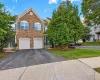 Stone veneer facade with gabled roofline, mature tree and garage Stone veneer facade with gabled roofline, mature tree and garage