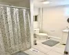 Full bath with vanity, light tile patterned flooring, and a shower with curtain Full bath with vanity, light tile patterned flooring, and a shower with curtain