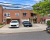 Brick facade with multiple windows, individual awnings, and integrated garage doors Brick facade with multiple windows, individual awnings, and integrated garage doors