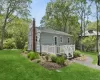 Rear view of house featuring a chimney, a yard, a wooden deck, and cooling unit Rear view of house featuring a chimney, a yard, a wooden deck, and cooling unit