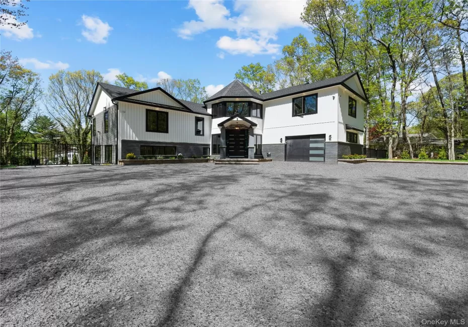 View of front of house featuring a garage and driveway View of front of house featuring a garage and driveway
