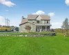 Two-story colonial with a covered front porch, and front lawn Two-story colonial with a covered front porch, and front lawn