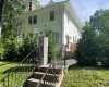 White siding exterior with a brick chimney White siding exterior with a brick chimney