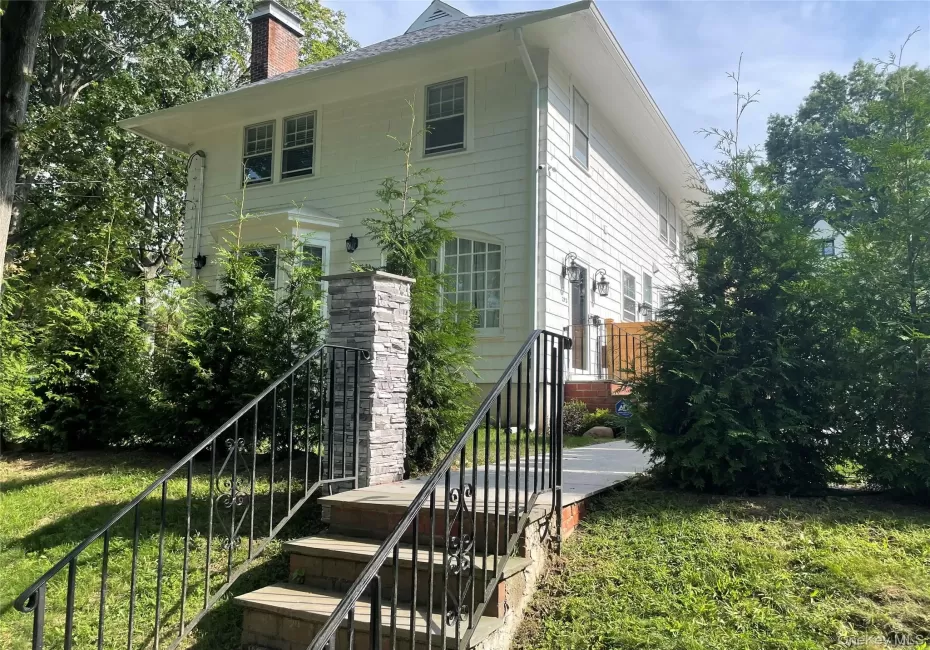 White siding exterior with a brick chimney White siding exterior with a brick chimney