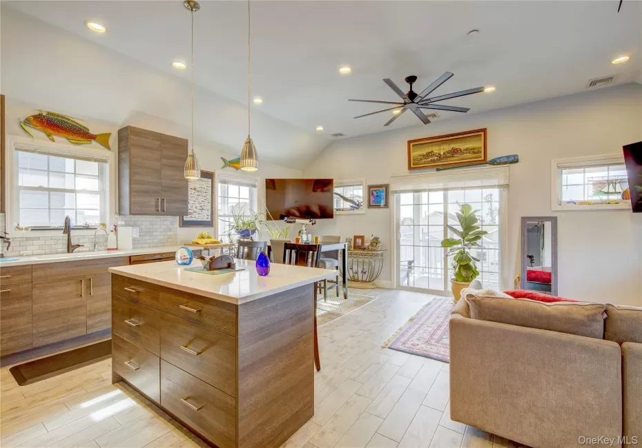Kitchen with a center island, open floor plan, recessed lighting, healthy amount of natural light, and tasteful backsplash Kitchen with a center island, open floor plan, recessed lighting, healthy amount of natural light, and tasteful backsplash