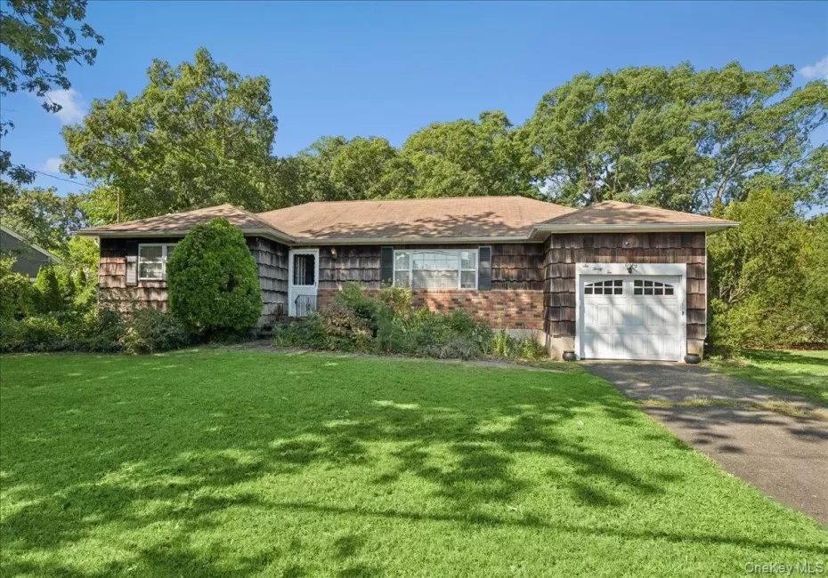 Ranch-style exterior with wood shingle siding and brick accents Ranch-style exterior with wood shingle siding and brick accents