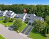 Aerial view of unit with attached one car garage and long driveway Aerial view of unit with attached one car garage and long driveway
