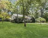 Expansive green lawn with mature trees and established landscaping Expansive green lawn with mature trees and established landscaping