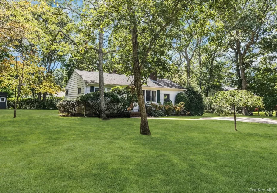 Expansive green lawn with mature trees and established landscaping Expansive green lawn with mature trees and established landscaping