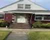 View of front of home with a shingled roof, brick siding, and a front yard View of front of home with a shingled roof, brick siding, and a front yard