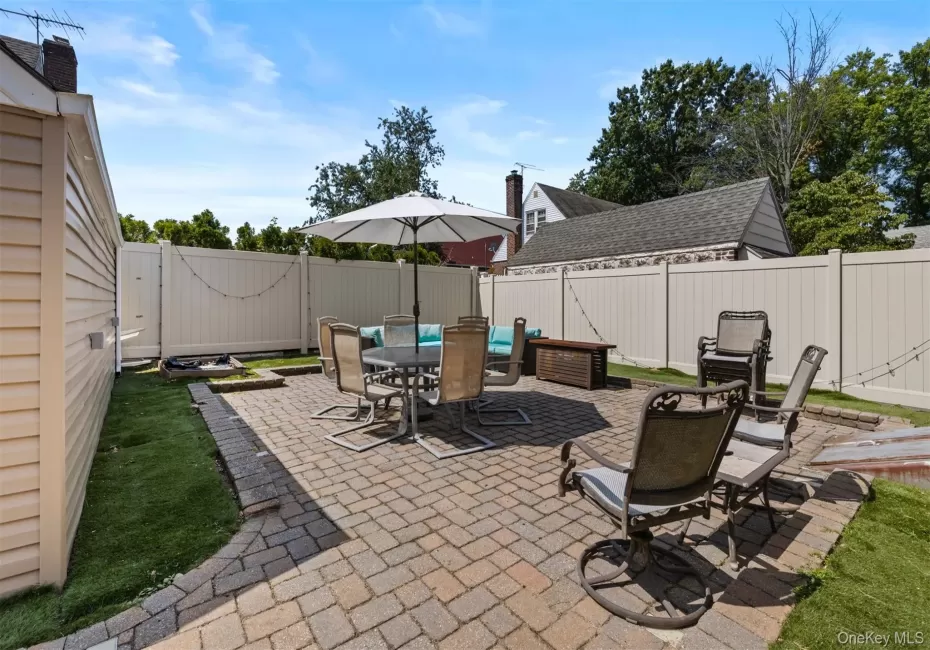 Fenced backyard featuring a patio area and outdoor dining space Fenced backyard featuring a patio area and outdoor dining space
