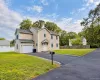Siding exterior with a covered entry, attached garage, and paved driveway Siding exterior with a covered entry, attached garage, and paved driveway