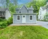 Light blue siding exterior with white trim windows and a white entry door Light blue siding exterior with white trim windows and a white entry door