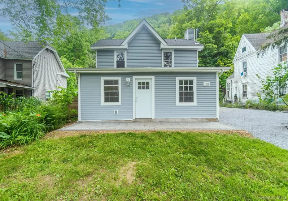 Light blue siding exterior with white trim windows and a white entry door Light blue siding exterior with white trim windows and a white entry door