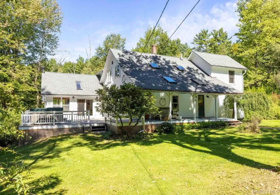 Exterior siding, covered front porch, skylights, pitched roof, and outdoor deck Exterior siding, covered front porch, skylights, pitched roof, and outdoor deck